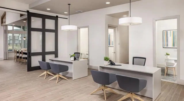 a workspace with furniture a chandelier and wooden floor