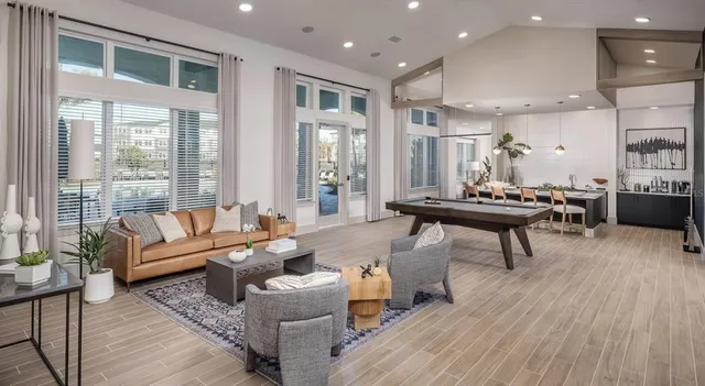 a living room with furniture and a wooden floor