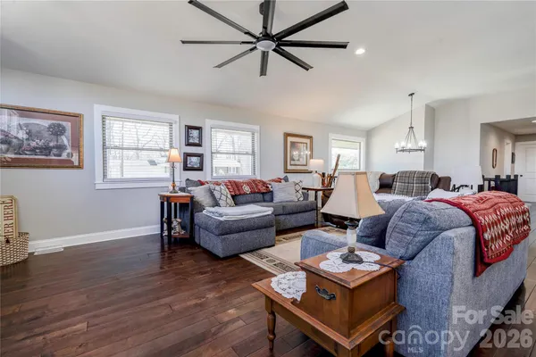 a living room with furniture a bed and a window