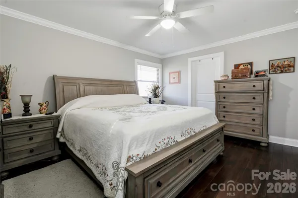 a large bed sitting in a bedroom next to a window