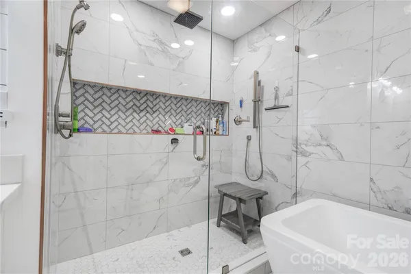 a bathroom with a bathtub and a shower