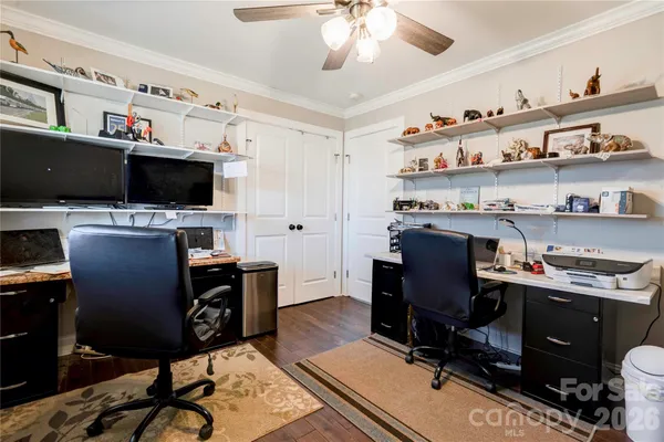 a view of a workspace with furniture and a window