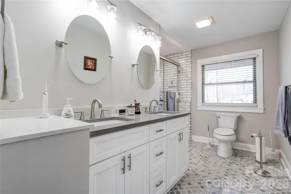 a bathroom with a toilet sink and mirror