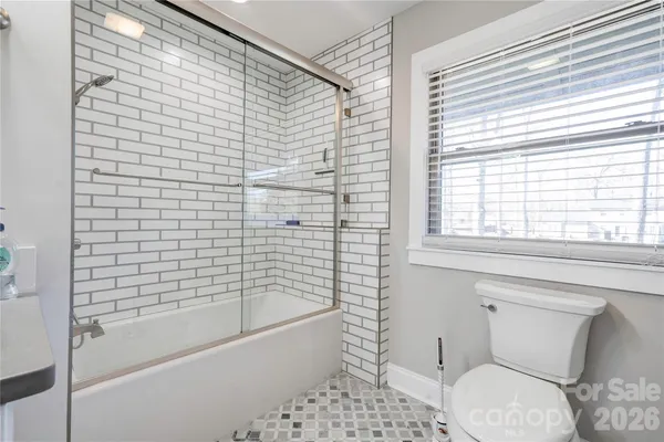 a bathroom with a toilet and bathtub