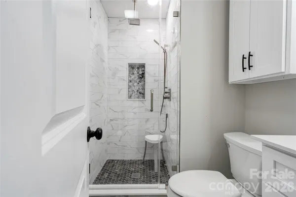 a white toilet sitting next to a bathroom sink