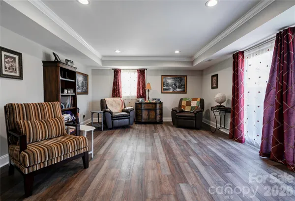 a living room with furniture a flat screen tv and a couch