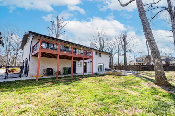 a view of a house with pool and a yard