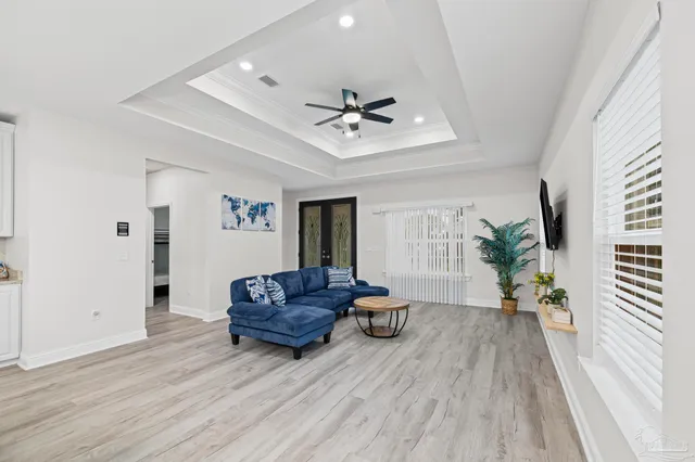 a living room with furniture and a potted plant