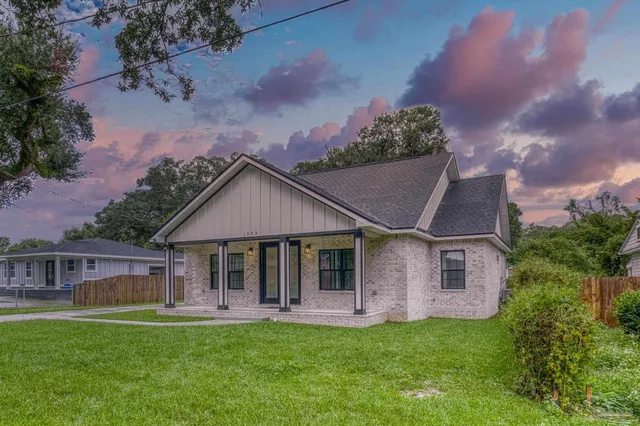 a front view of a house with a garden