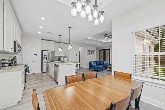 a large kitchen with a table and chairs
