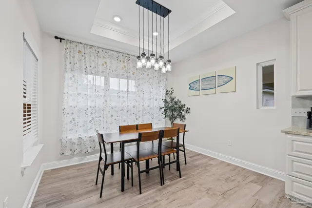 a dining room with furniture and chandelier