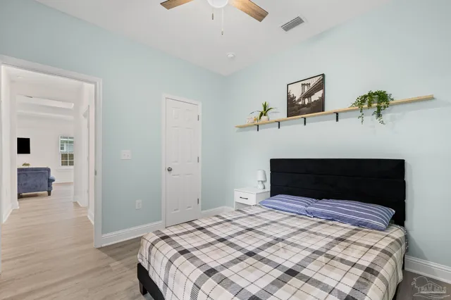 a bedroom with a bed and a view of kitchen