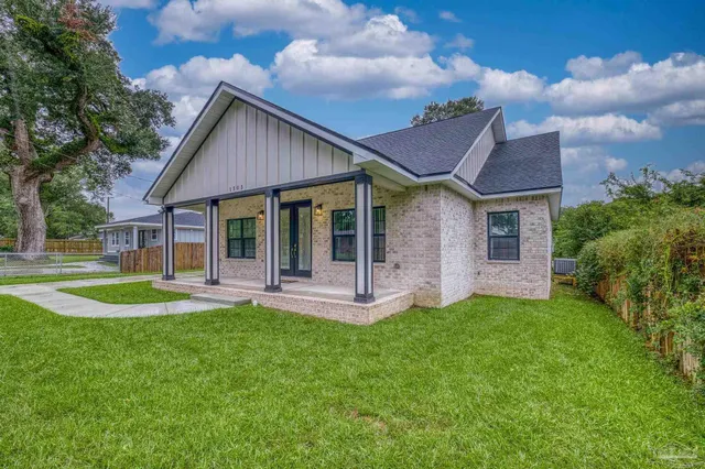 a front view of a house with a yard and porch