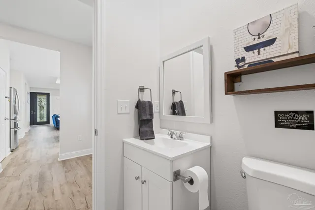 a view of a patio with table and chairs with wooden floor and fence