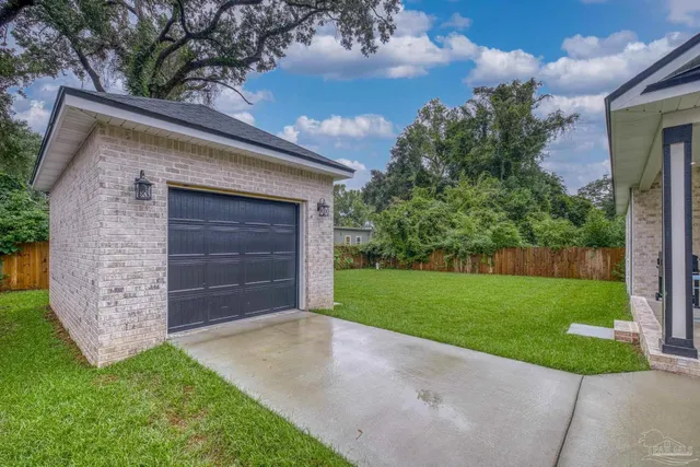 a view of a backyard with table and chairs and a large tree