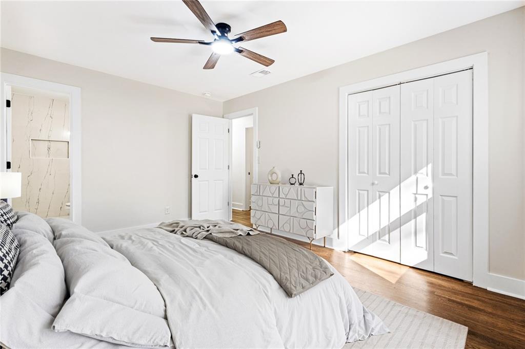 4976 Mable Lake Drive Southwest Mableton, GA 30126 - Photo 15 of 18 a bedroom with a large bed and a chandelier
