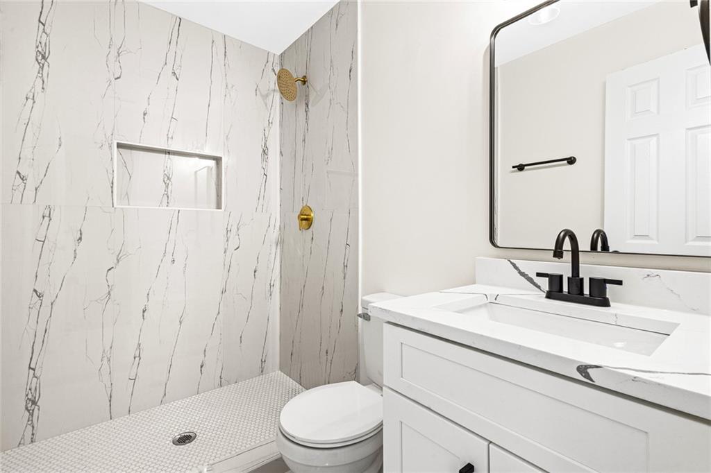 4976 Mable Lake Drive Southwest Mableton, GA 30126 - Photo 18 of 18 a bathroom with a sink a toilet and shower