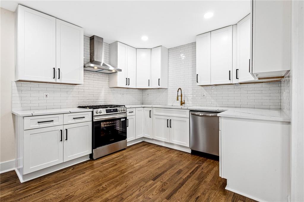 4976 Mable Lake Drive Southwest Mableton, GA 30126 - Photo 5 of 18 a kitchen with stainless steel appliances granite countertop a stove a sink and white cabinets