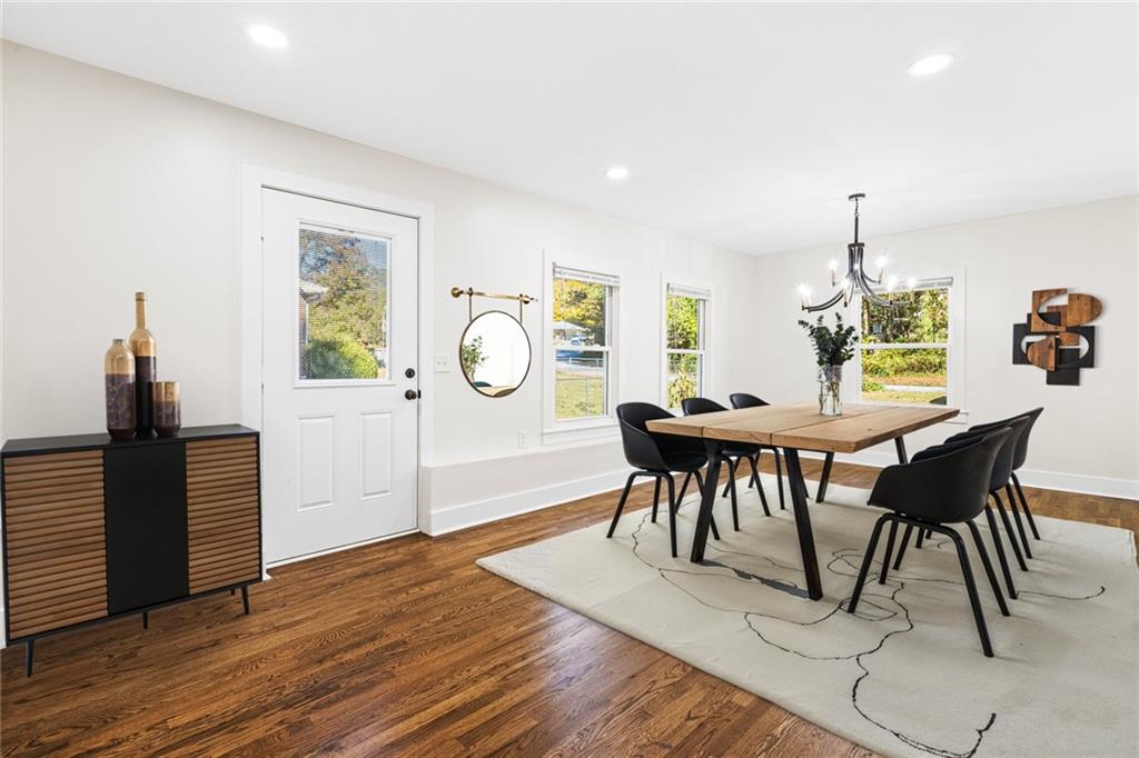 4976 Mable Lake Drive Southwest Mableton, GA 30126 - Photo 6 of 18 a view of a dining room with furniture and wooden floor