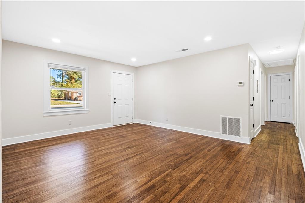 4976 Mable Lake Drive Southwest Mableton, GA 30126 - Photo 9 of 18 a view of an empty room with wooden floor and a window