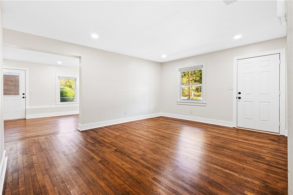 4976 Mable Lake Drive Southwest Mableton, GA 30126 - Photo 10 of 18 an empty room with wooden floor and windows