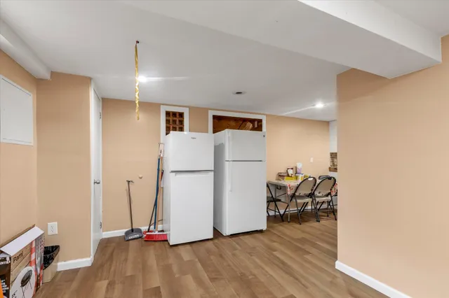 a view of a room with wooden floor and a sink