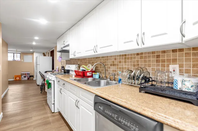 a kitchen with lots of counter top space and wooden floor