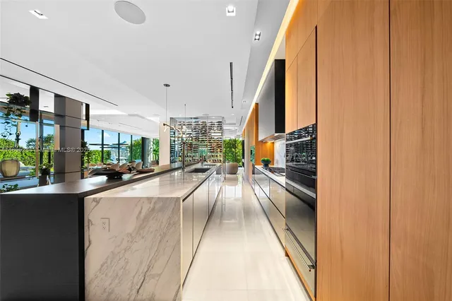 a large bedroom with a large window and a flat screen tv