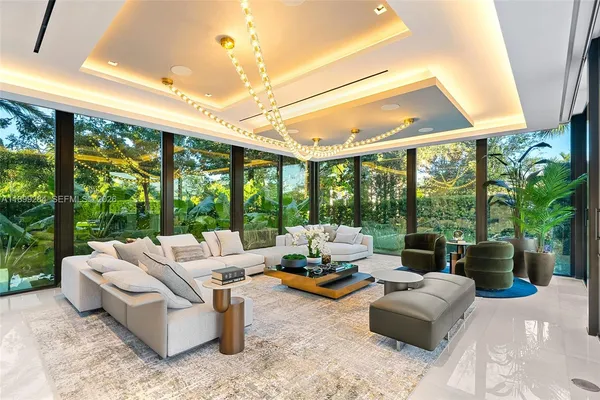 a living room with chairs and a large window