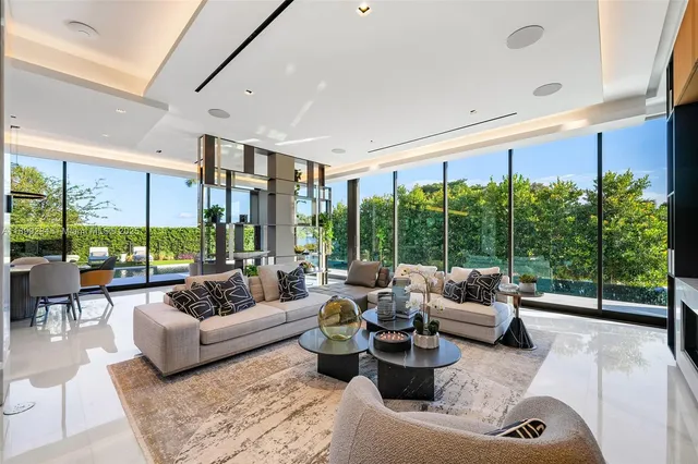 a view of a hallway with furniture and a large window