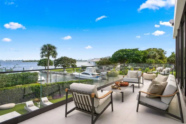 a view of a chairs and table in patio with a yard