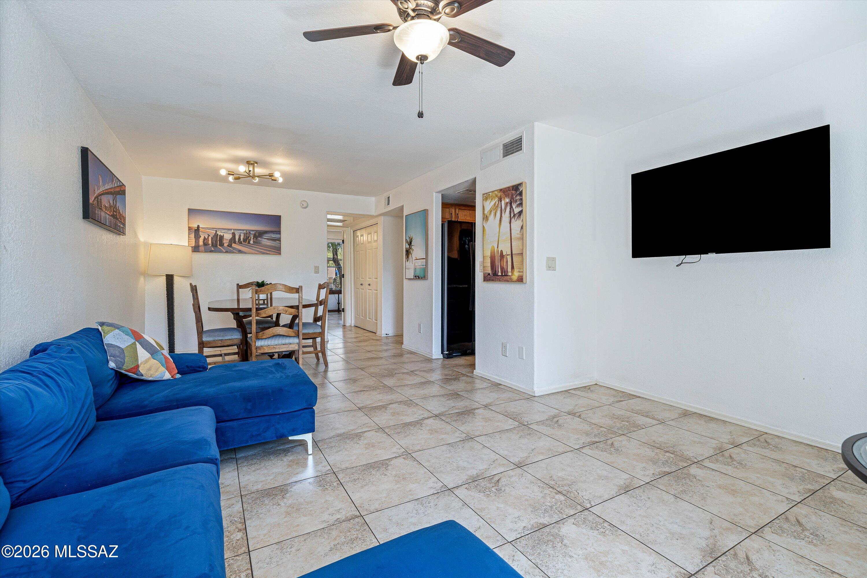 5800 North Kolb Road, Unit 5125 Tucson, AZ 85750 - Photo 3 of 34 a living room with furniture and a flat screen tv