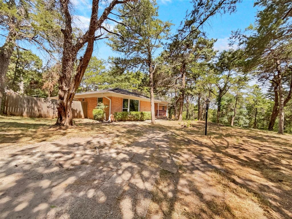 a backyard of a house with large trees