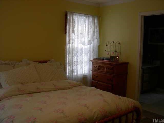 112 Fieldspring Lane Raleigh, NC 27606 - Photo 7 of 10 a bedroom with a bed and a dresser