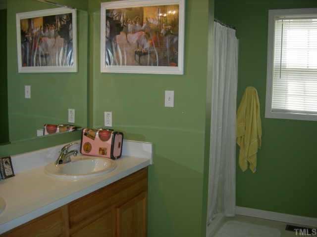 112 Fieldspring Lane Raleigh, NC 27606 - Photo 8 of 10 a bathroom with a sink and a mirror