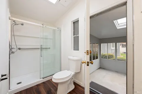 a bathroom with a toilet a sink and shower