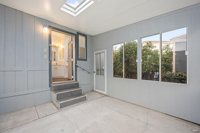 a view of a porch with wooden floor and stairs