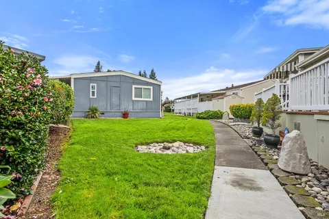 a view of a house with backyard and garden