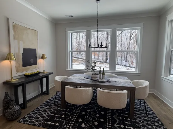 a view of a dining room with furniture window and wooden floor