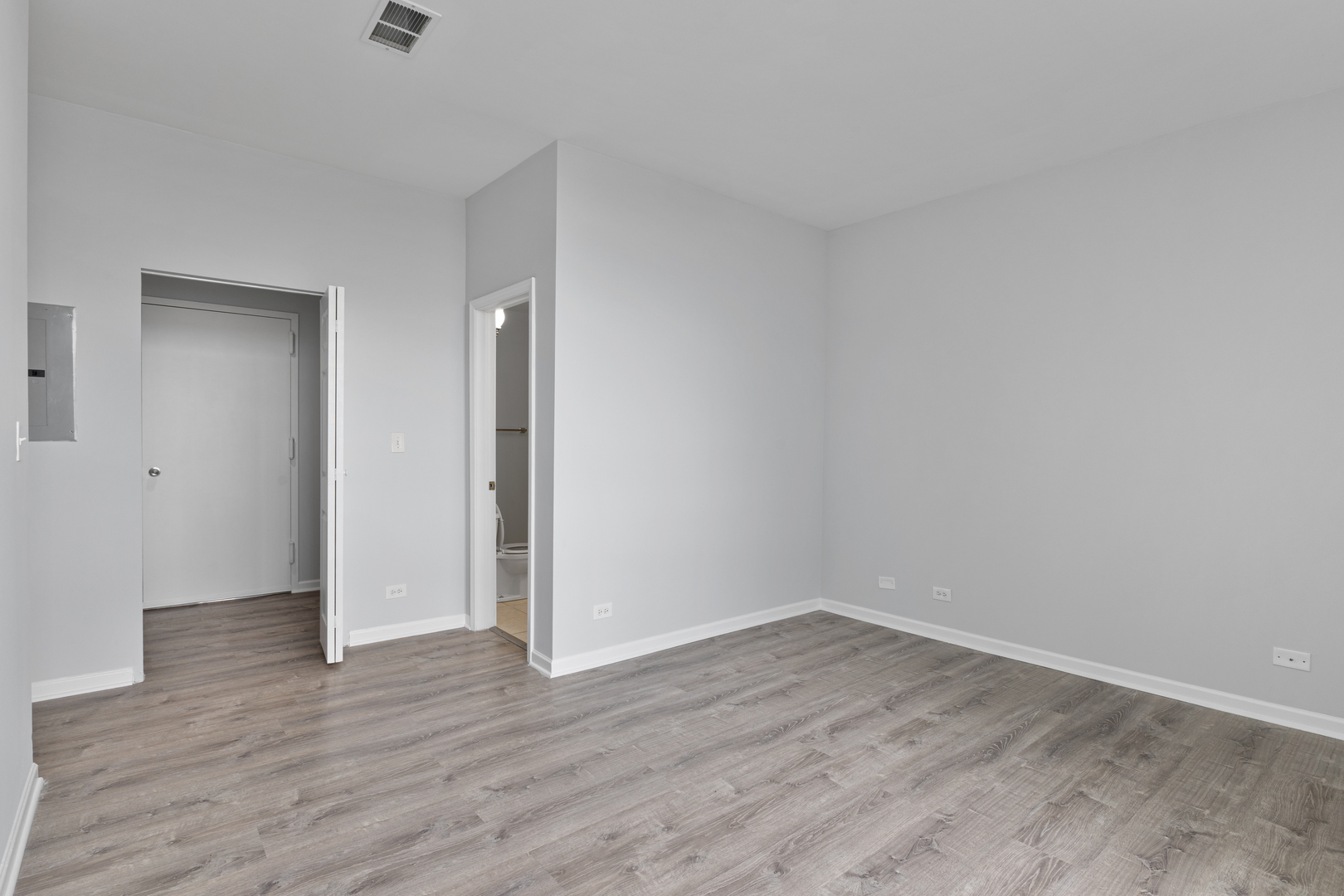 2451 West Howard Street, Unit 406 Chicago, IL 60645 - Photo 8 of 15 a view of an empty room with wooden floor