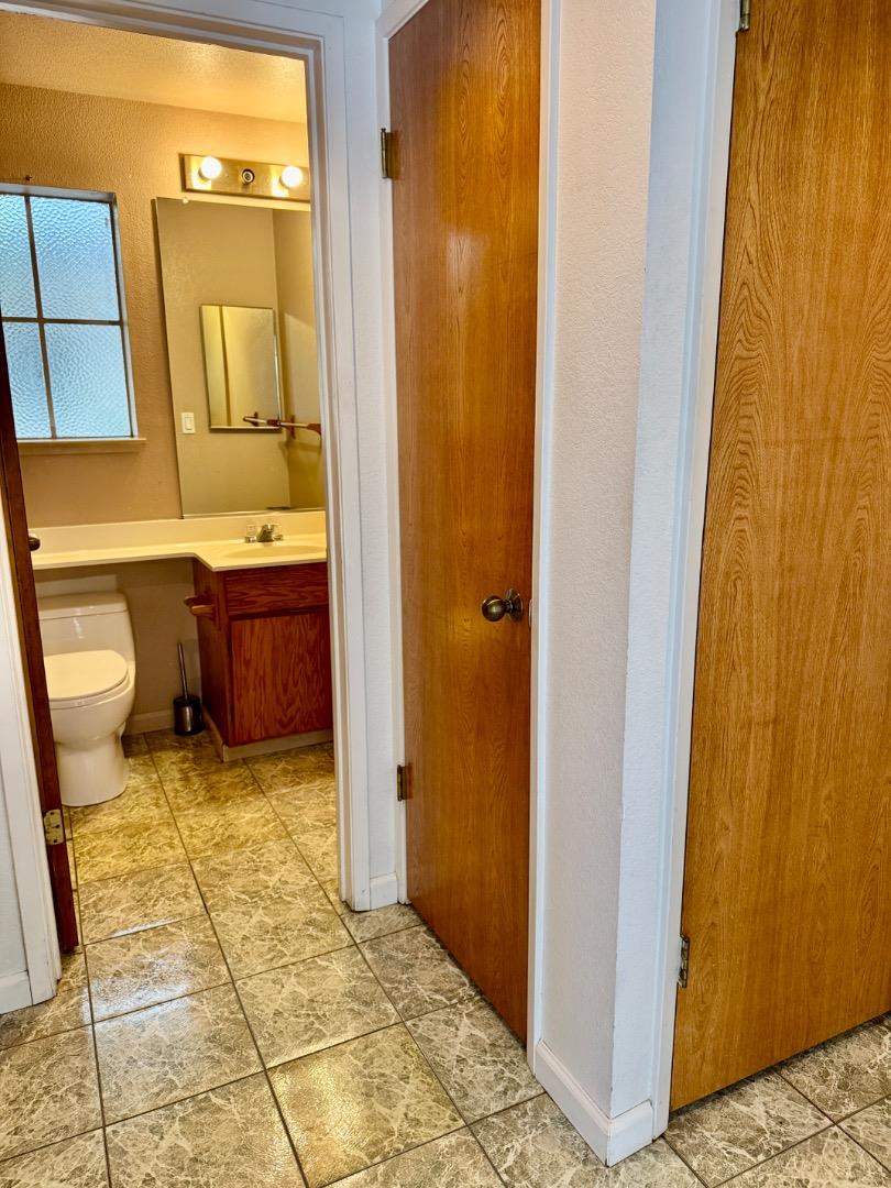 460 Pine Avenue Half Moon Bay, CA 94019 - Photo 13 of 21 a bathroom with a granite countertop sink and a mirror