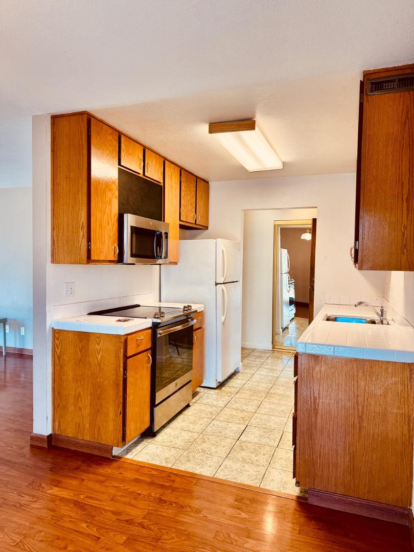 460 Pine Avenue Half Moon Bay, CA 94019 - Photo 2 of 21 a kitchen with stainless steel appliances granite countertop a stove a sink and a refrigerator