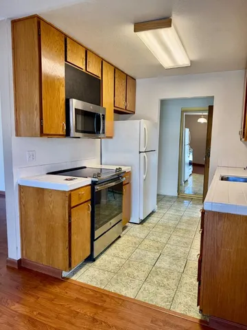 a kitchen with stainless steel appliances granite countertop a stove a microwave and a refrigerator