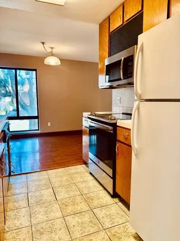 a kitchen with stainless steel appliances a stove a sink and a microwave