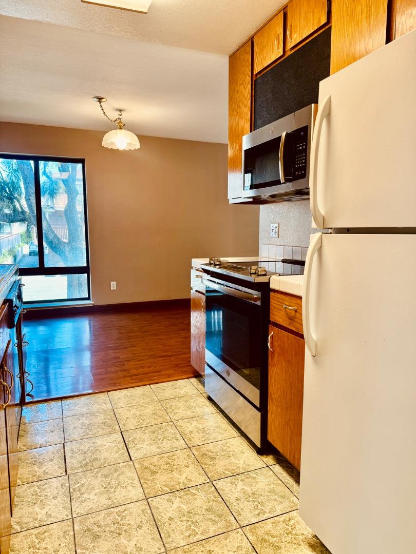 460 Pine Avenue Half Moon Bay, CA 94019 - Photo 5 of 21 a kitchen with stainless steel appliances a stove a sink and a microwave