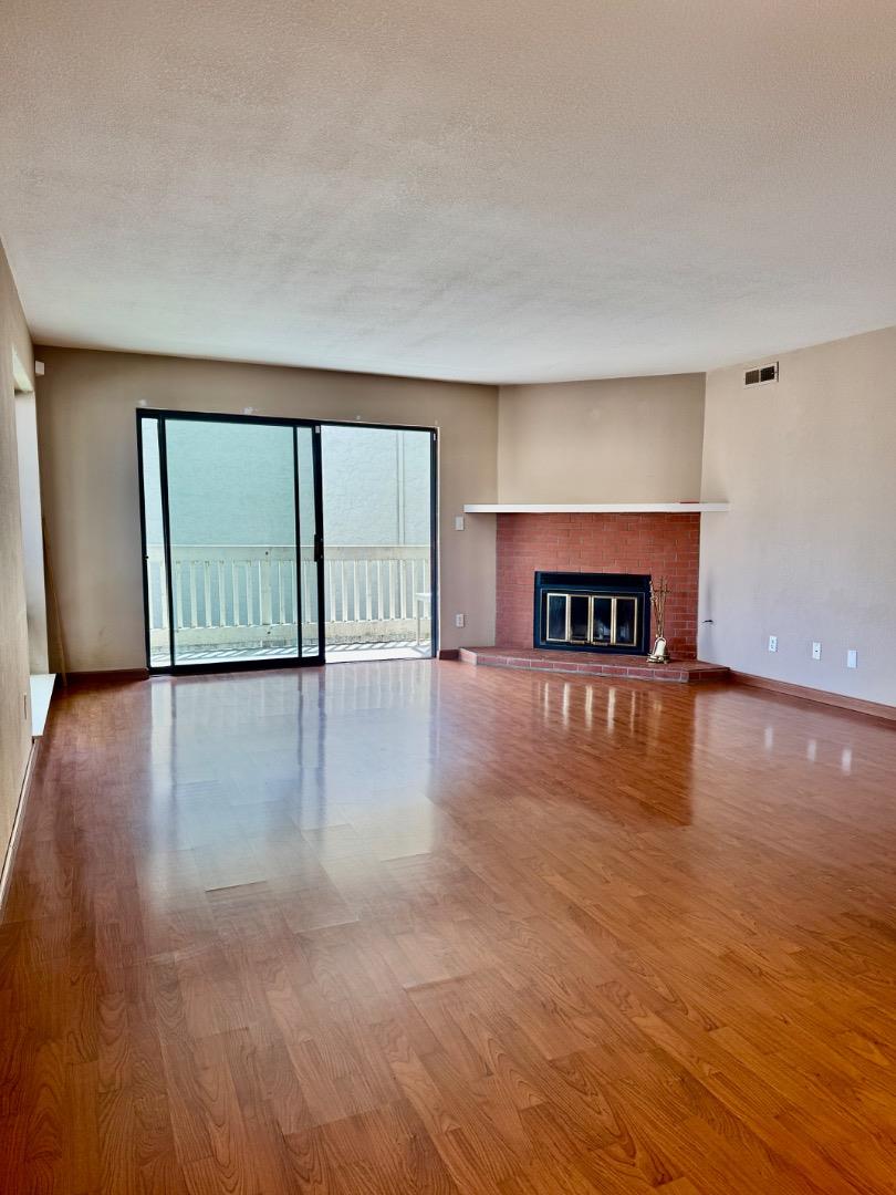 460 Pine Avenue Half Moon Bay, CA 94019 - Photo 6 of 21 a view of an empty room with window and wooden floor