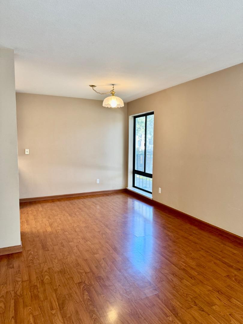 460 Pine Avenue Half Moon Bay, CA 94019 - Photo 7 of 21 an empty room with wooden floor and windows