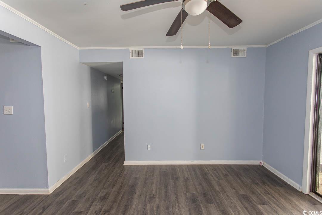 950 Forestbrook Road, Unit C3 Myrtle Beach, SC 29579 - Photo 2 of 19 Unfurnished room featuring dark wood-style flooring, ornamental molding, and a ceiling fan