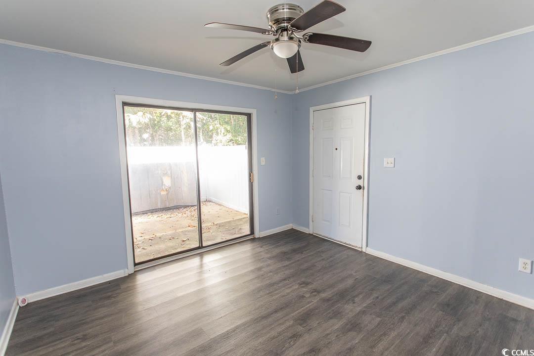 950 Forestbrook Road, Unit C3 Myrtle Beach, SC 29579 - Photo 3 of 19 Spare room with ornamental molding, dark wood-style flooring, and a ceiling fan