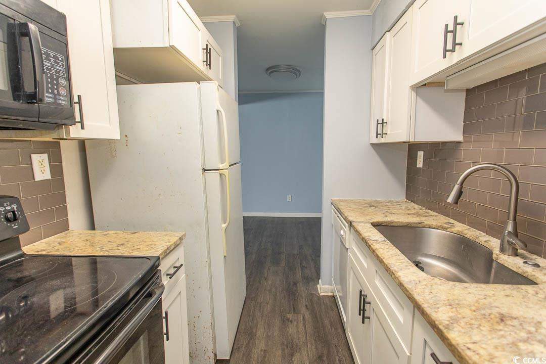 950 Forestbrook Road, Unit C3 Myrtle Beach, SC 29579 - Photo 5 of 19 Kitchen featuring tasteful backsplash, black appliances, and white cabinets